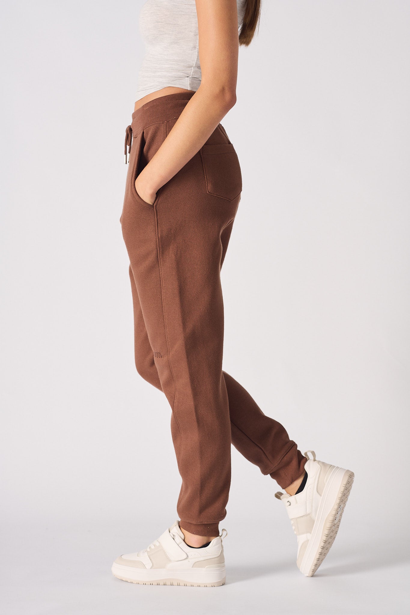 side profile of woman in brown tapered joggers