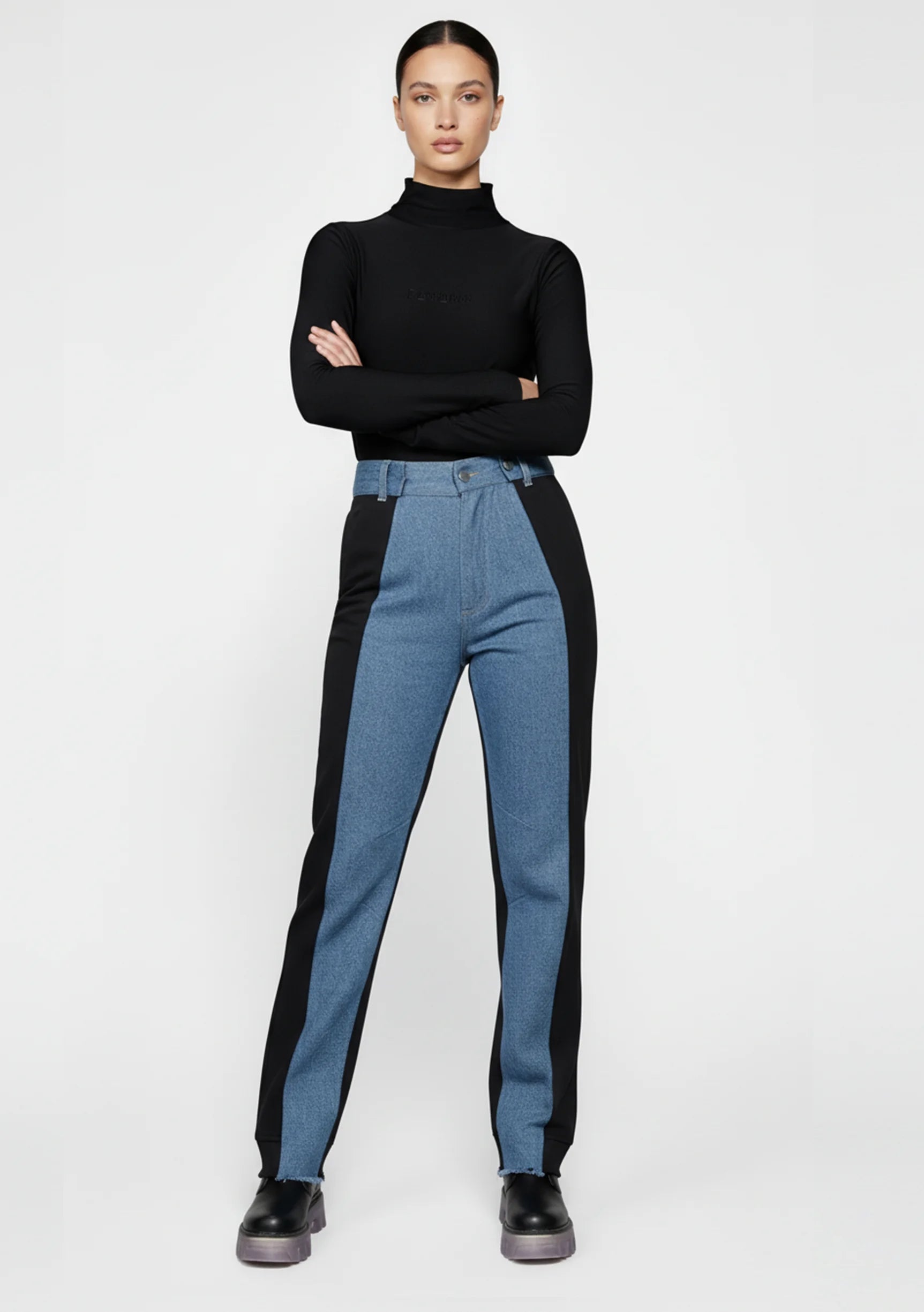 Side profile of a model walking in women's color block denim, emphasizing the straight leg silhouette.