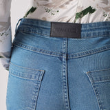 Back view of the women's contrast mid-blue skinny jean laid flat.