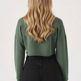 Back view showing the comfortable fit of the womens cropped green jumper.
