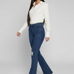 Womens dark blue distressed denim flare trousers side view
