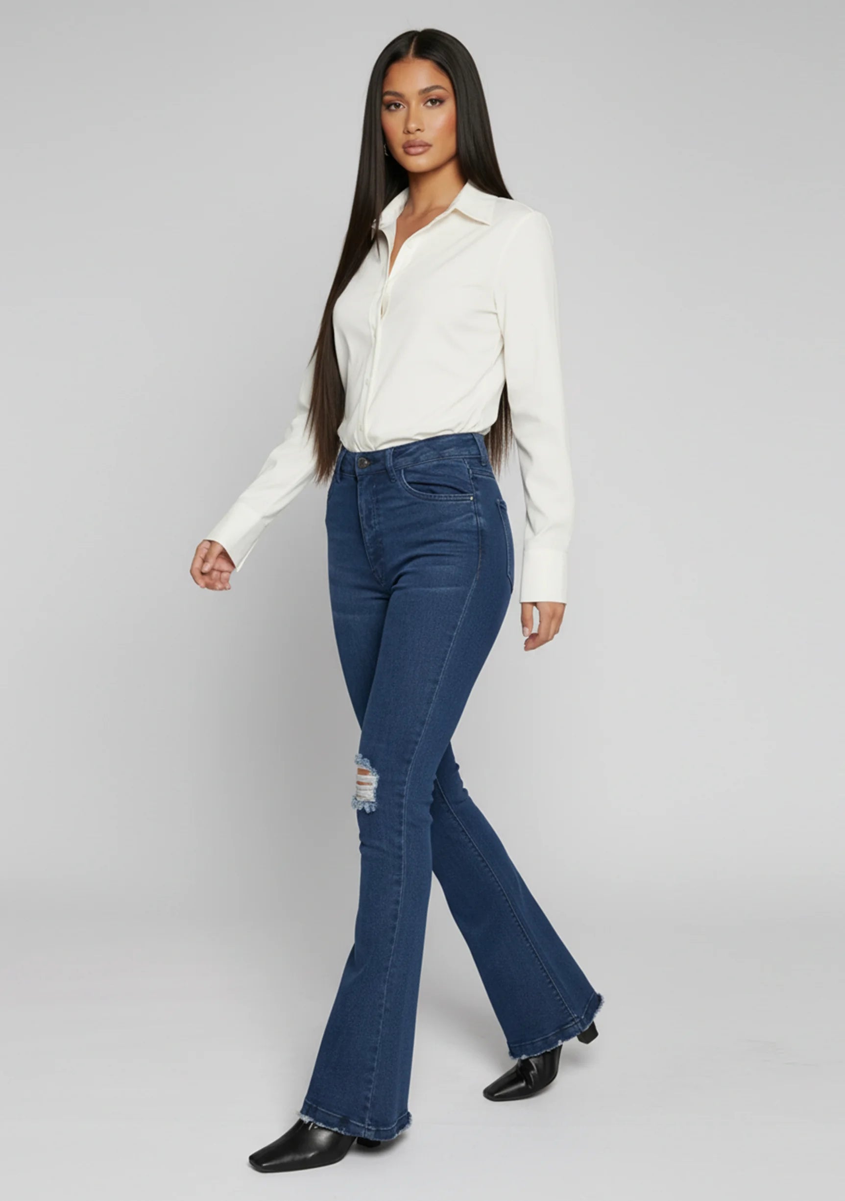 Womens dark blue distressed denim flare trousers side view