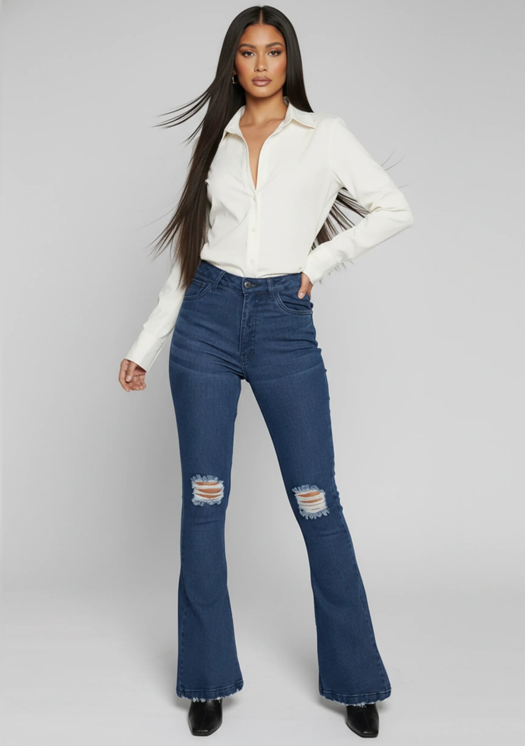 Womens dark blue distressed flare jeans dynamic front view