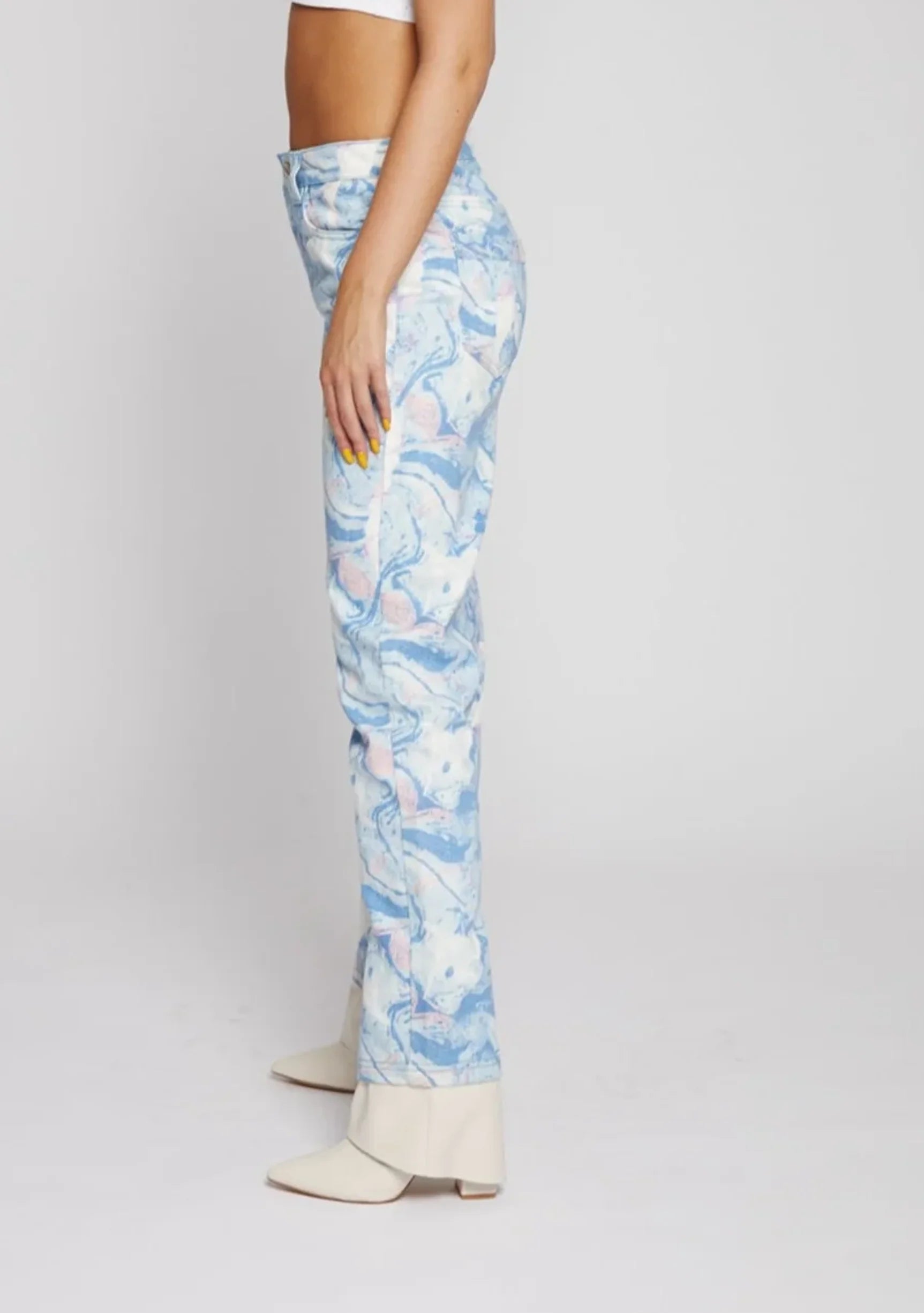 Side profile view of women's fluid print straight fit pants showcasing the unique light blue swirl pattern.