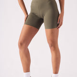 Close up front view of khaki green cycling shorts for women showing the fabric texture