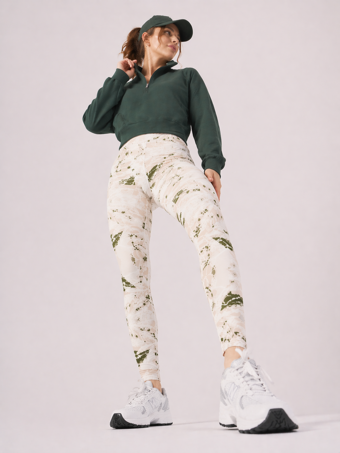 A woman in womens-green-stone-print-high-waist-leggings standing in an active pose showing the print detail and full length fit