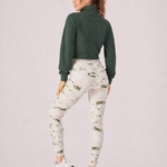 A woman wearing womens-green-stone-print-high-waist-leggings back view showing the wide dipped waistband and full length fit