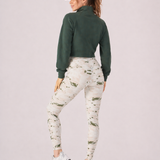 A woman wearing womens-green-stone-print-high-waist-leggings back view showing the wide dipped waistband and full length fit