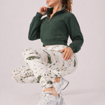 A woman in womens-green-stone-print-high-waist-leggings performing a squat showing full stretch and movement in the fabric