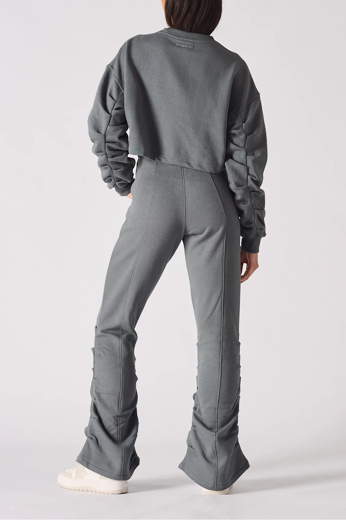 Rear view of a charcoal grey crew neck jumper showing the relaxed fit and back silhouette