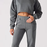 Front view of a charcoal grey cropped jumper for women with a simple crew neck