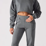 Front view of a charcoal grey cropped jumper for women with a simple crew neck