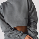 Close up detail of the unique ruched sleeves on a charcoal grey jumper
