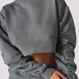 Close up detail of the unique ruched sleeves on a charcoal grey jumper