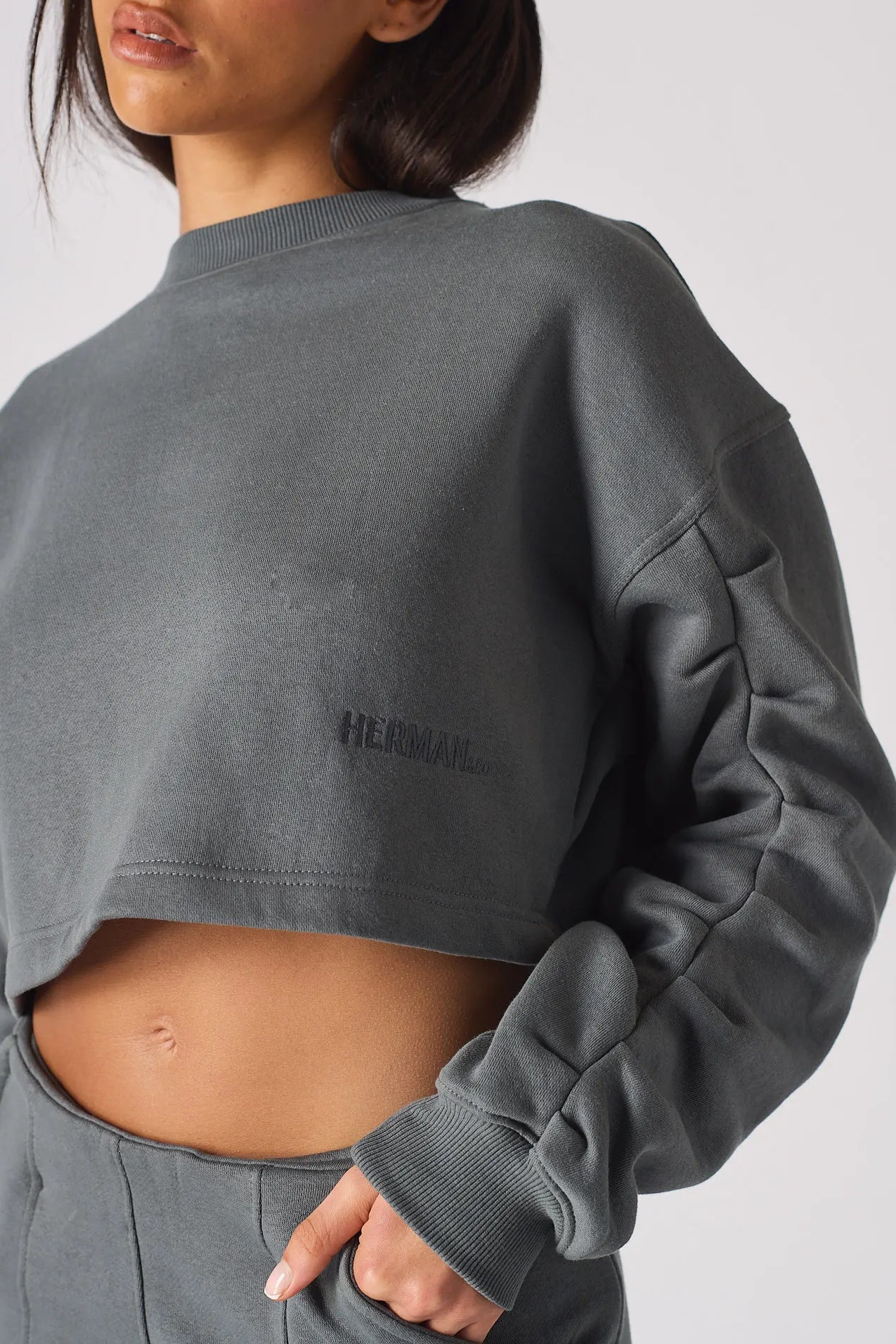 Side view close up showing the artfully sculpted ruched sleeve design