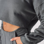 A detailed look at the soft charcoal grey fabric and the cropped fit at the waist