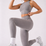 A woman wearing womens-grey-racerback-training-crop-top in a kneeling lunge pose showing the fitted cut