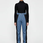 Front view of women's high-rise dual color denim featuring light blue front and black side panels.
