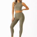 A woman wearing womens-khaki-high-waist-shaping-leggings styled with a matching khaki crop tank and cream cap, front view