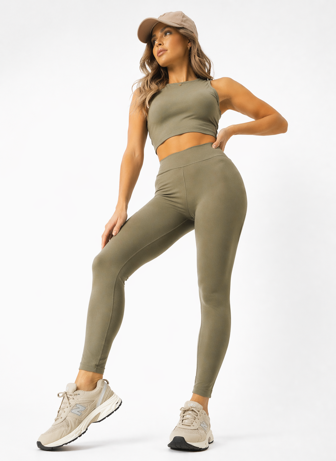 A woman in womens-khaki-high-waist-leggings in an active lunge pose showing full range of movement and flexibility