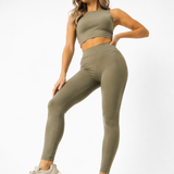 A woman in womens-khaki-high-waist-leggings in an active lunge pose showing full range of movement and flexibility