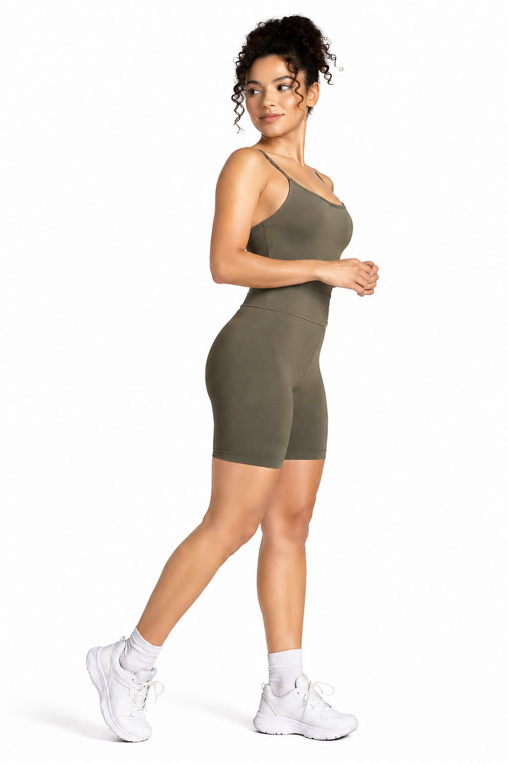 A woman wearing womens-khaki-strappy-tummy-control-unitard side view walking showing the high waist panel and fitted cut