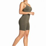 A woman wearing womens-khaki-strappy-tummy-control-unitard side view walking showing the high waist panel and fitted cut