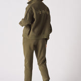 Rear view of a khaki sweatshirt showing the funnel neck and relaxed fit