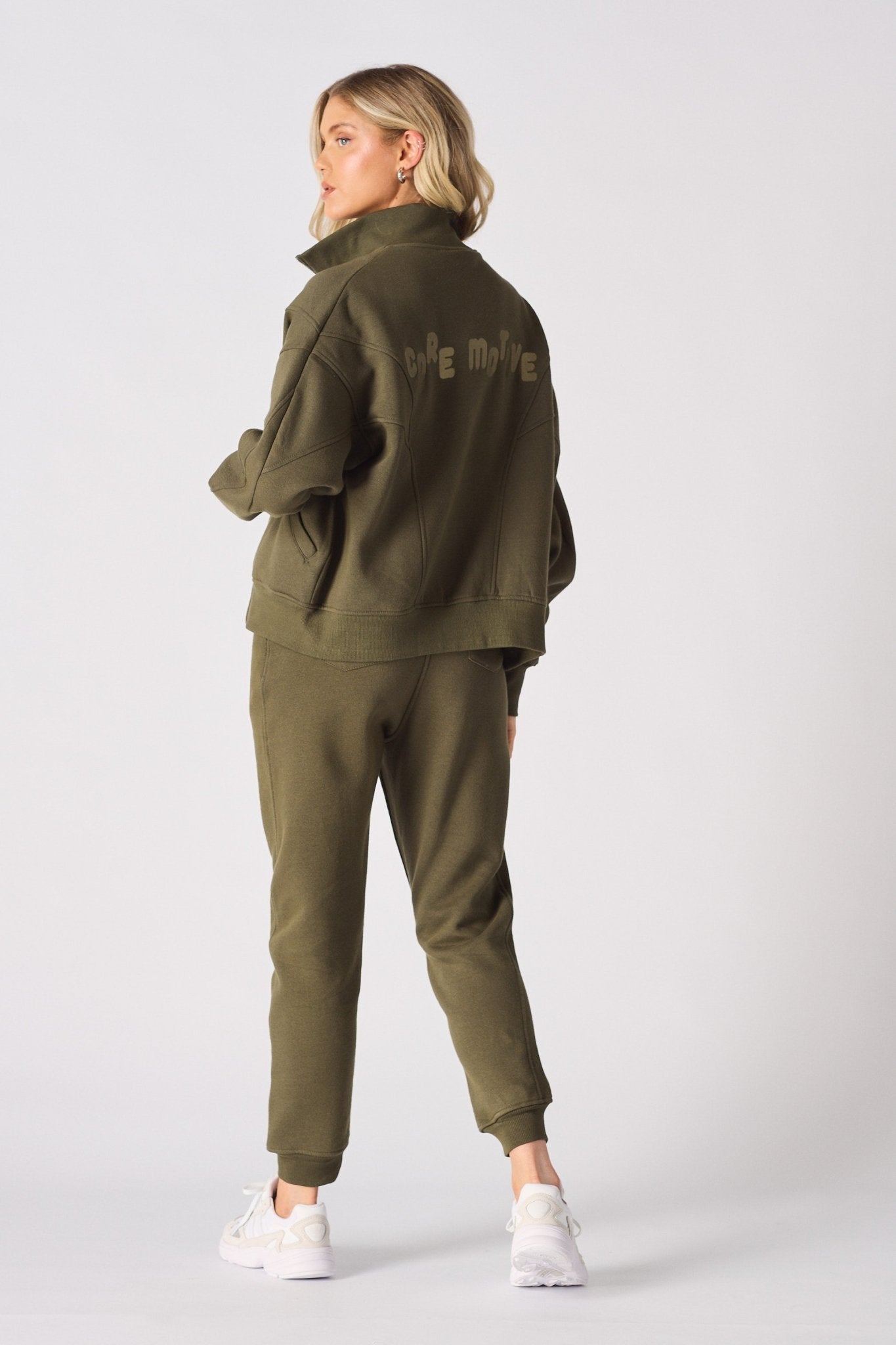 Rear view of a khaki sweatshirt showing the funnel neck and relaxed fit
