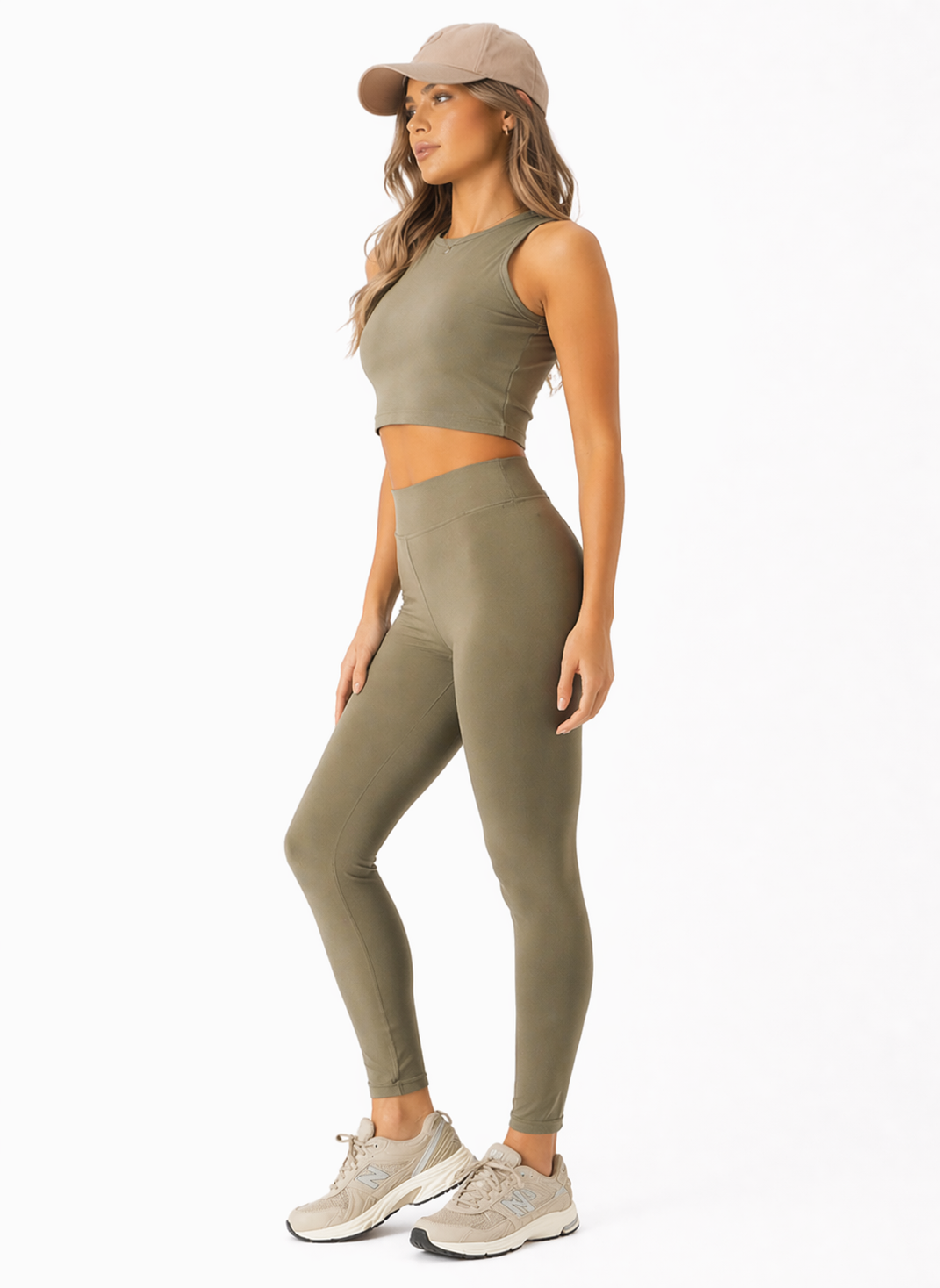 A woman wearing womens-khaki-high-waist-tummy-control-leggings side view showing the shaping fit and deep waistband