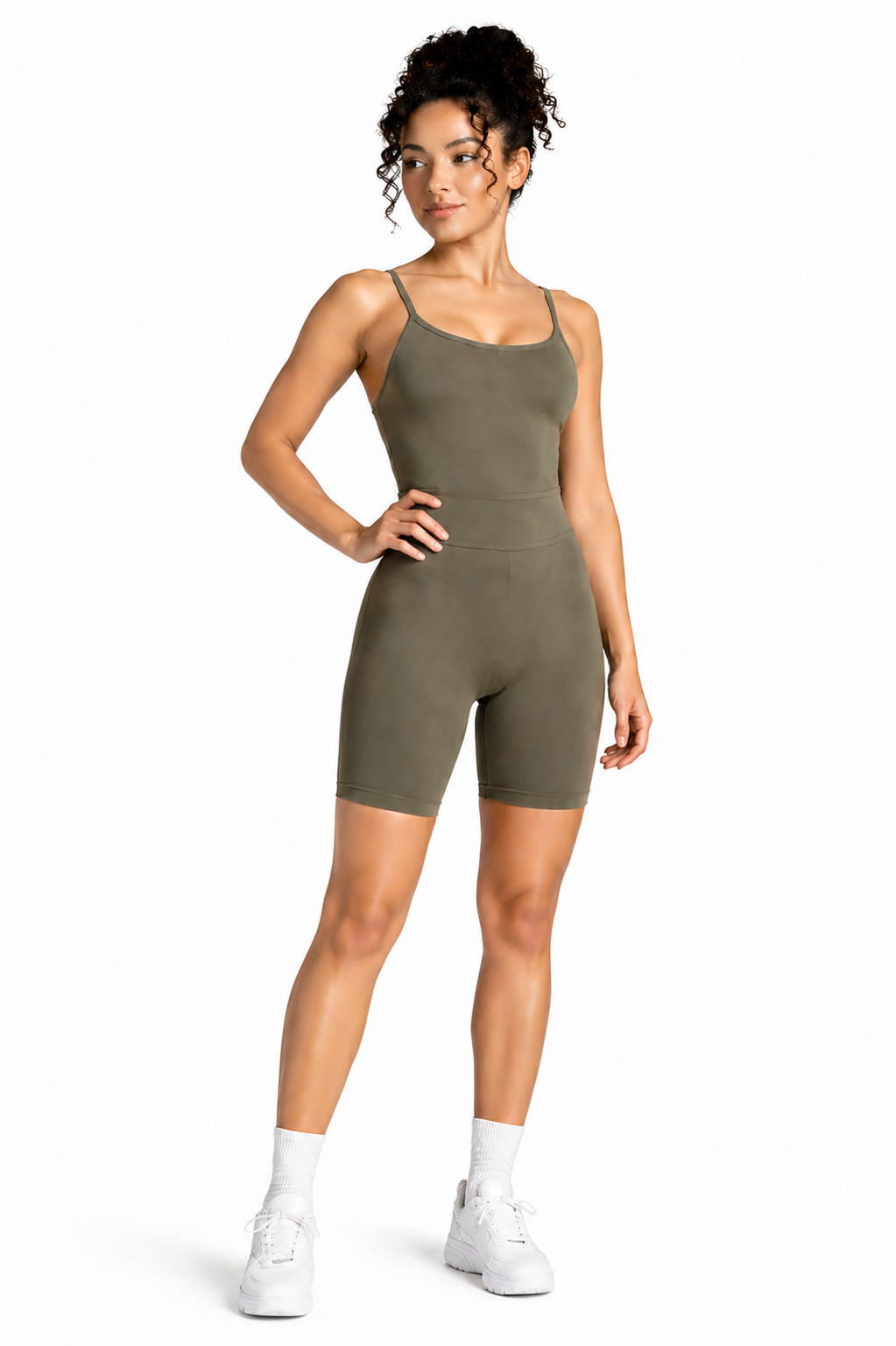 A woman wearing womens-khaki-strappy-unitard front view showing the scoop neckline and smooth tummy control panel