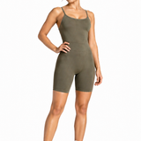 A woman wearing womens-khaki-strappy-unitard front view showing the scoop neckline and smooth tummy control panel