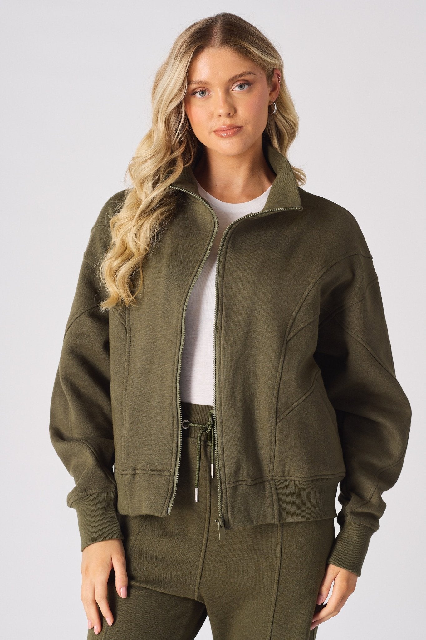 Front view of a khaki sweatshirt for women with a structured funnel neck