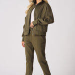 Side view of a model in a khaki sweatshirt and matching joggers