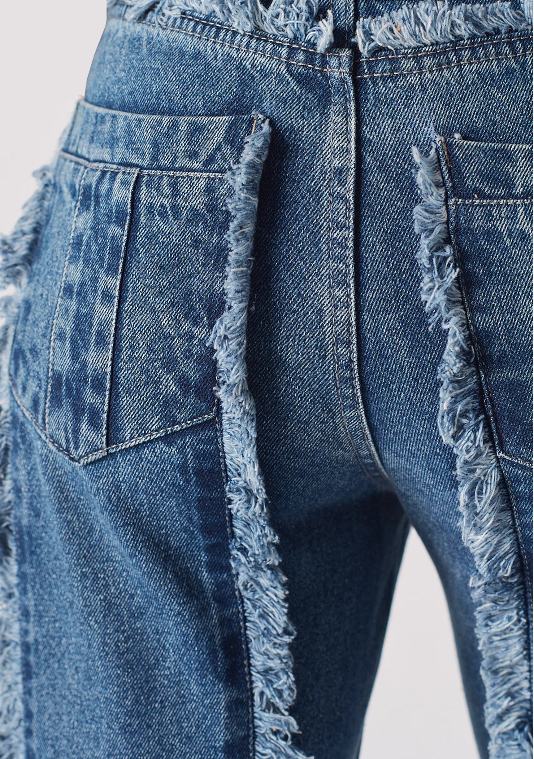 Back pocket and frayed seam detail on Womens Mid Blue Wash jeans