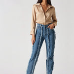 Full body standing shot of Womens Mid Blue Wash frayed seam jeans