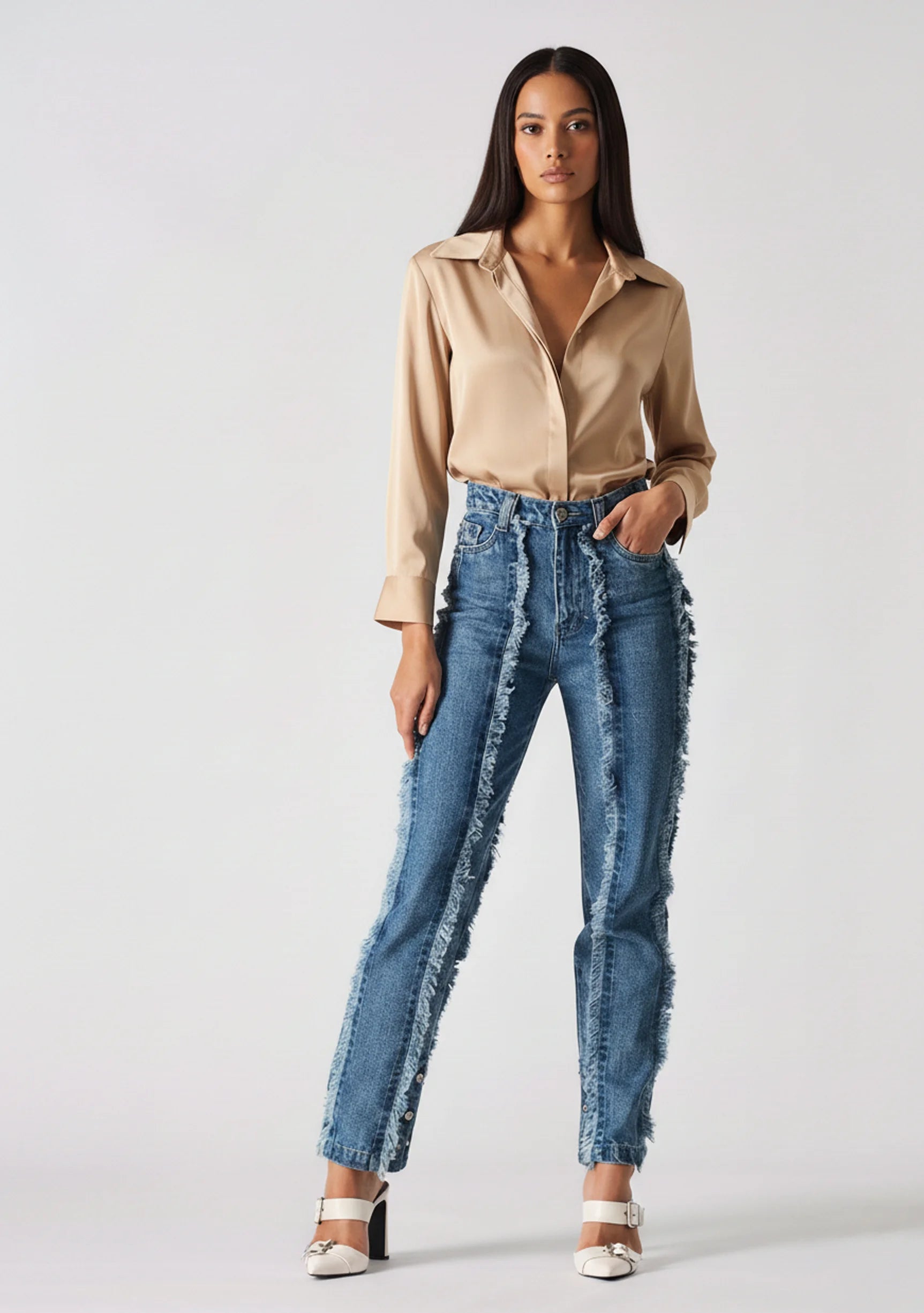 Full body standing shot of Womens Mid Blue Wash frayed seam jeans