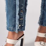 Silver popper hem detail on Womens Mid Blue Wash frayed seam jeans