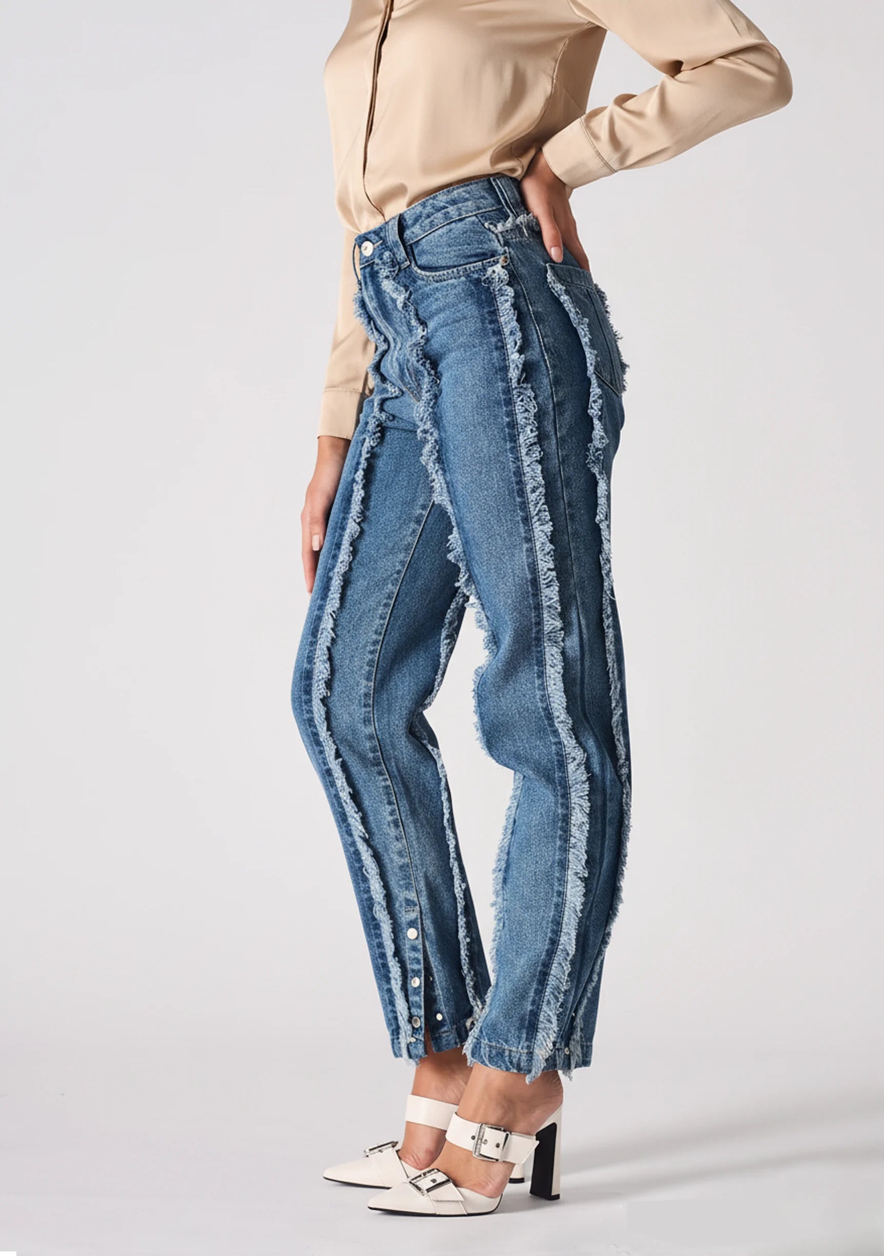 Side profile of Womens Mid Blue Wash frayed seam jeans