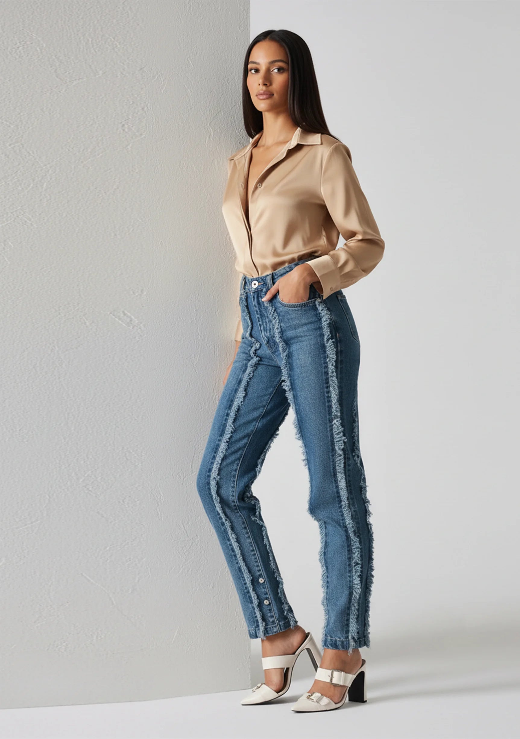 Side profile walk of Womens Mid Blue Wash frayed seam jeans