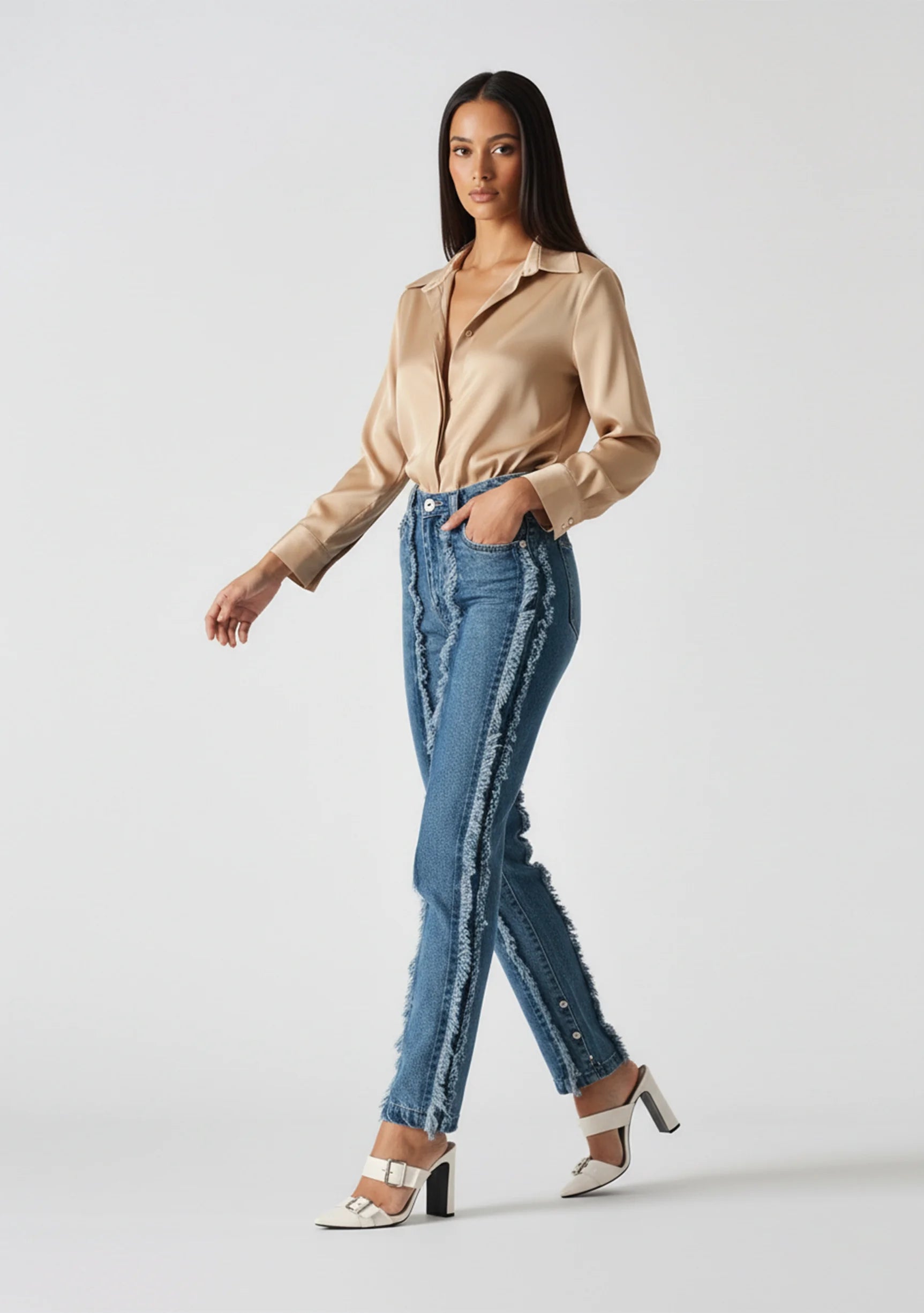 Walking view of Womens Mid Blue Wash frayed seam straight leg jeans