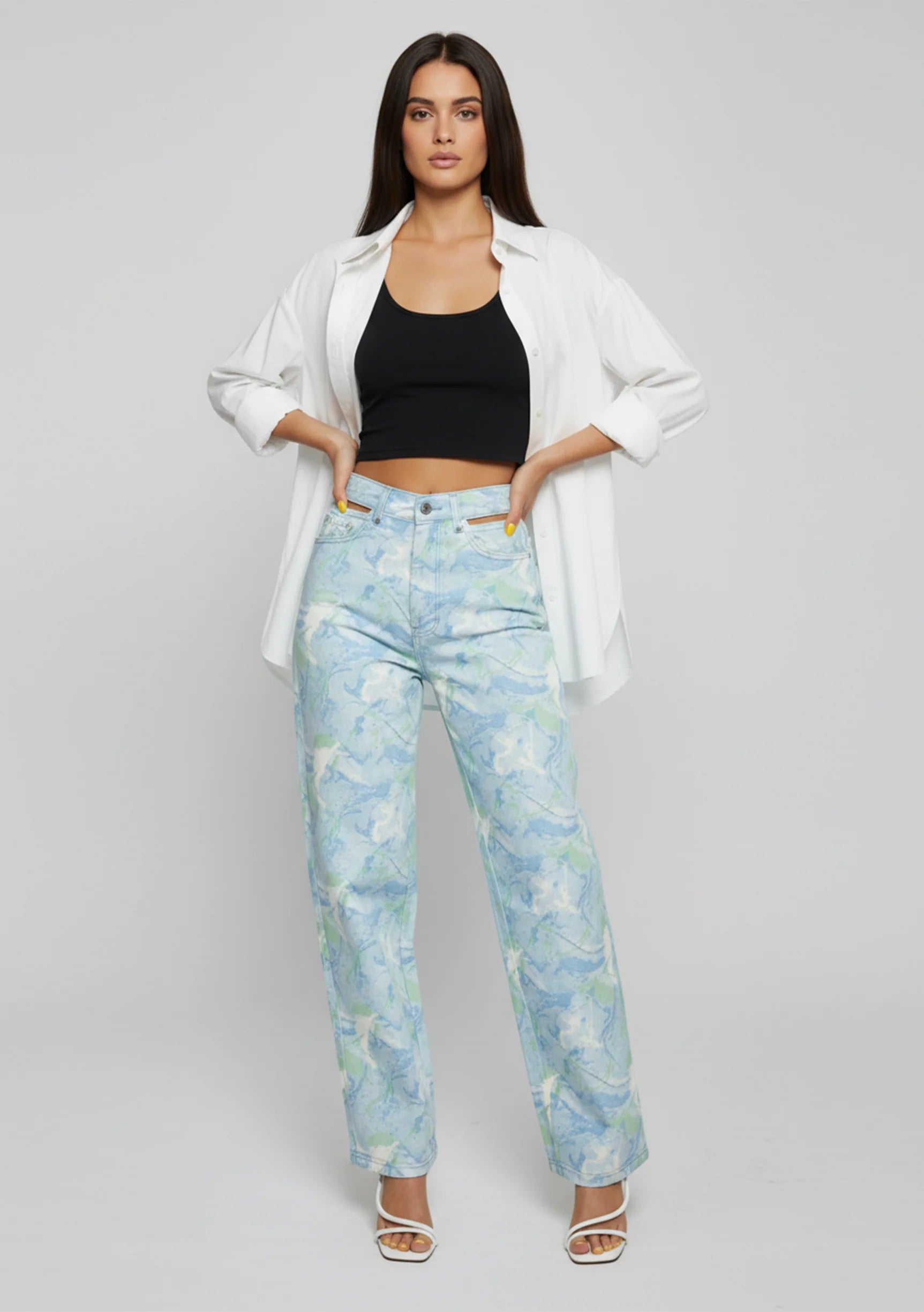 Front view of Womens Psychedelic Marble jeans with hand on waist detail