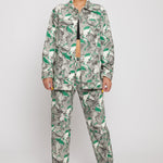 A model styled in the women's psychedelic print jeans with a matching jacket.