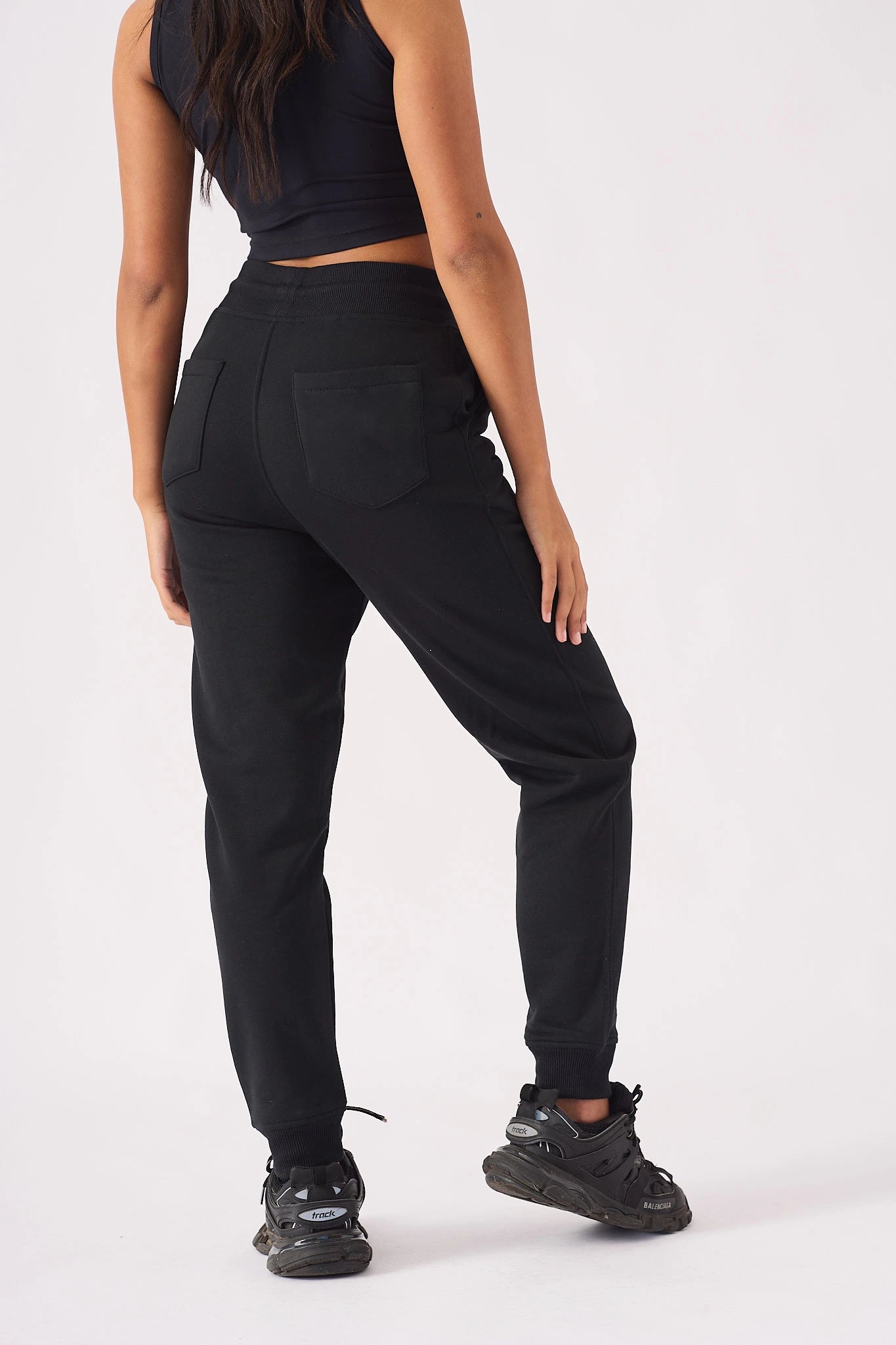 Back view of womens relaxed interlock pintuck jogger in black