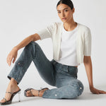 Model seated on the floor wearing Women's Speckled Blue Grey Casual Jeans
