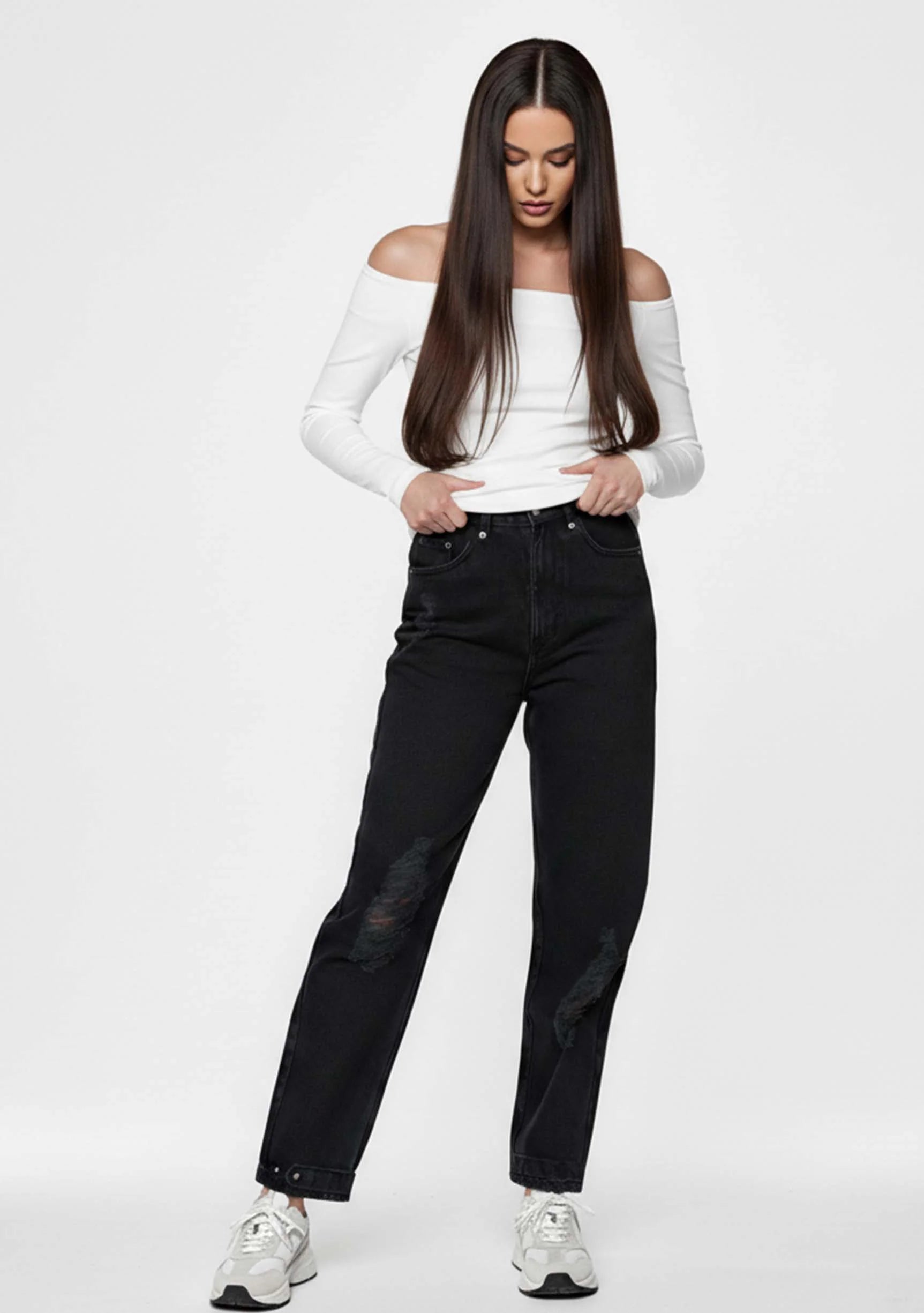 Model looking down while posing in Women's Straight Leg Black Denim Pants
