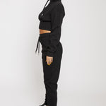 Side profile of the women's black tapered joggers showing the slim fit
