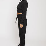 Side profile of the women's black tapered joggers showing the slim fit