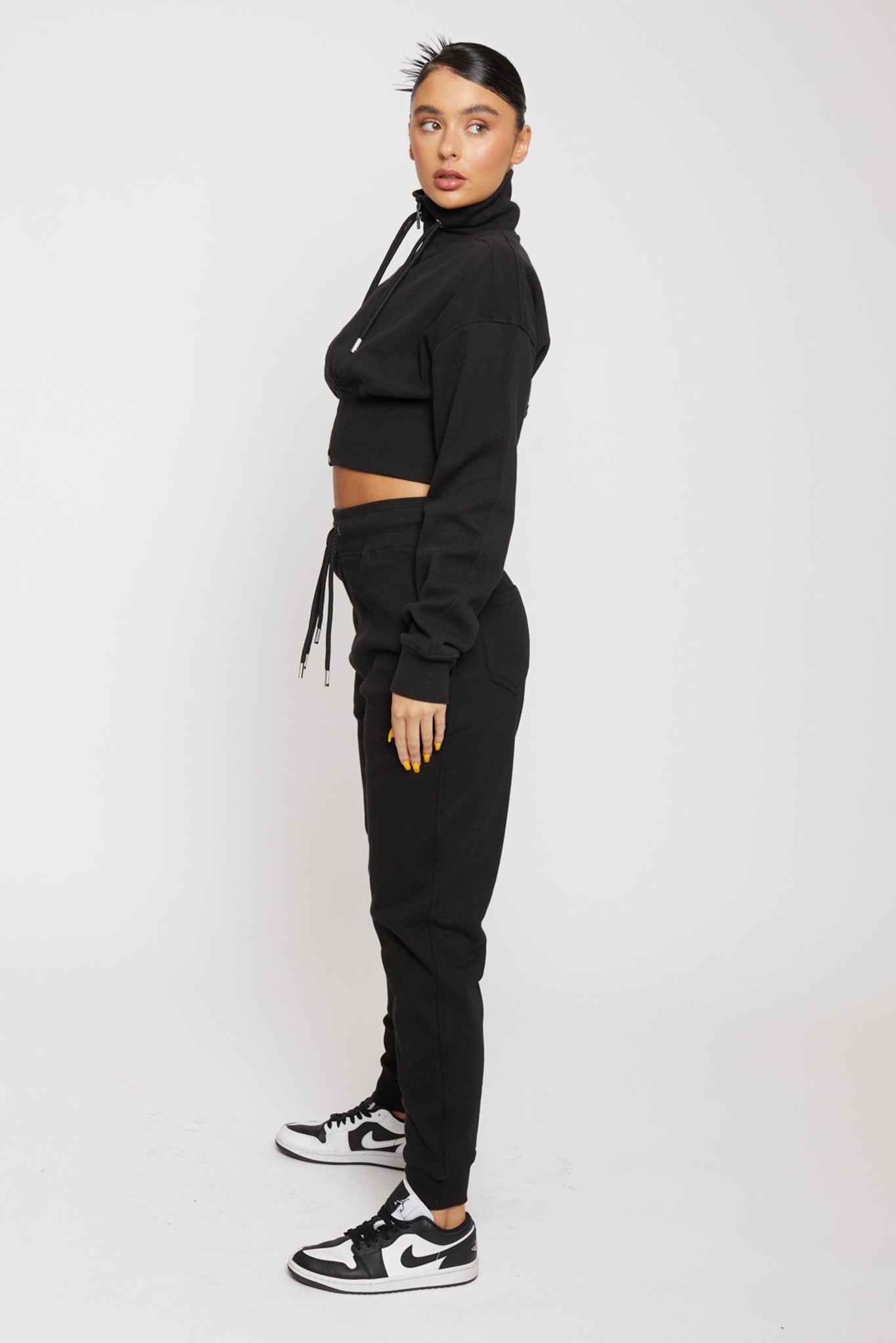 Side profile of the women's black tapered joggers showing the slim fit