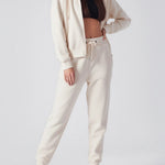 A woman standing in high quality womens white zip up hoodies for a clean look.